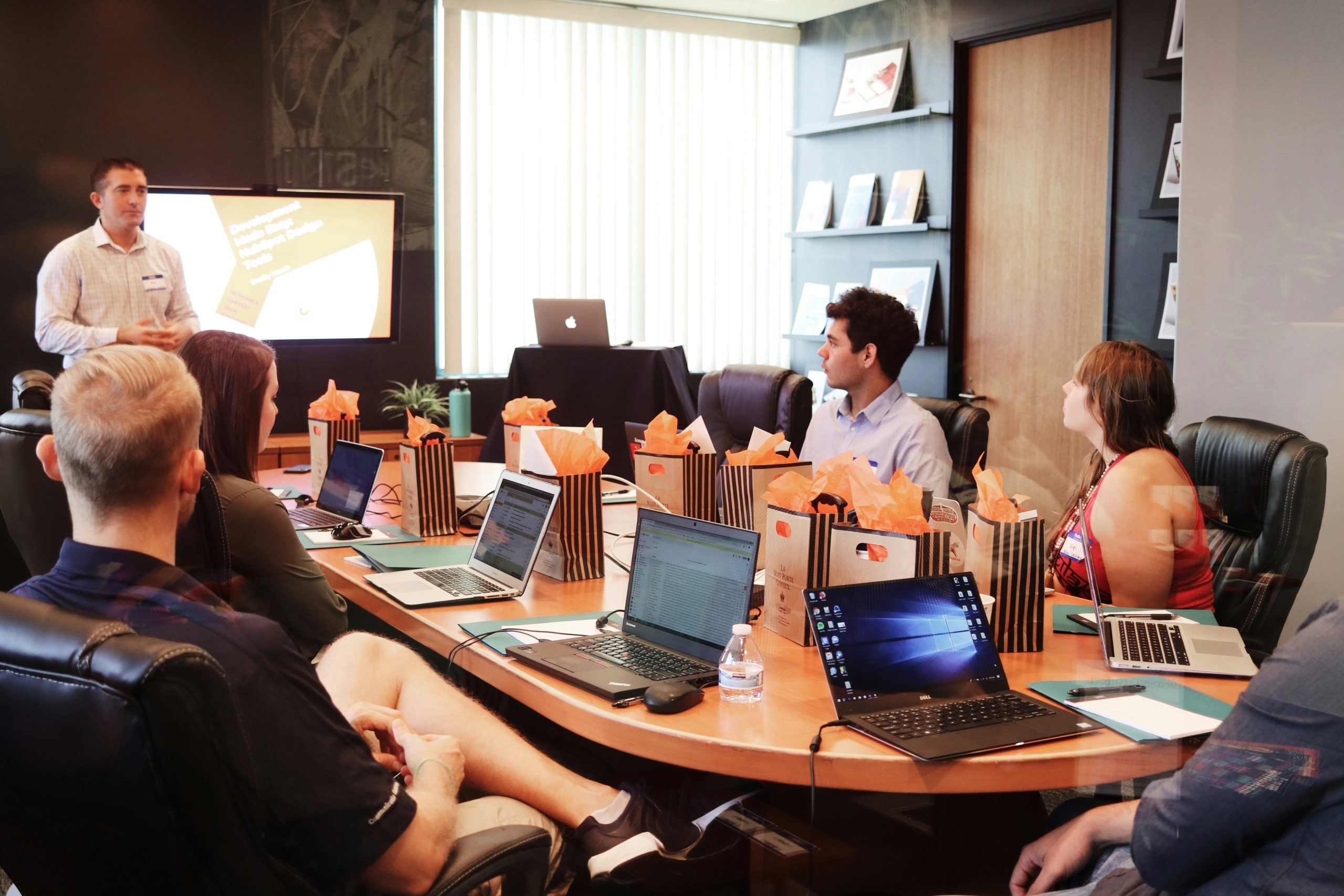 Corporate training session with a presenter and engaged participants in a conference room.